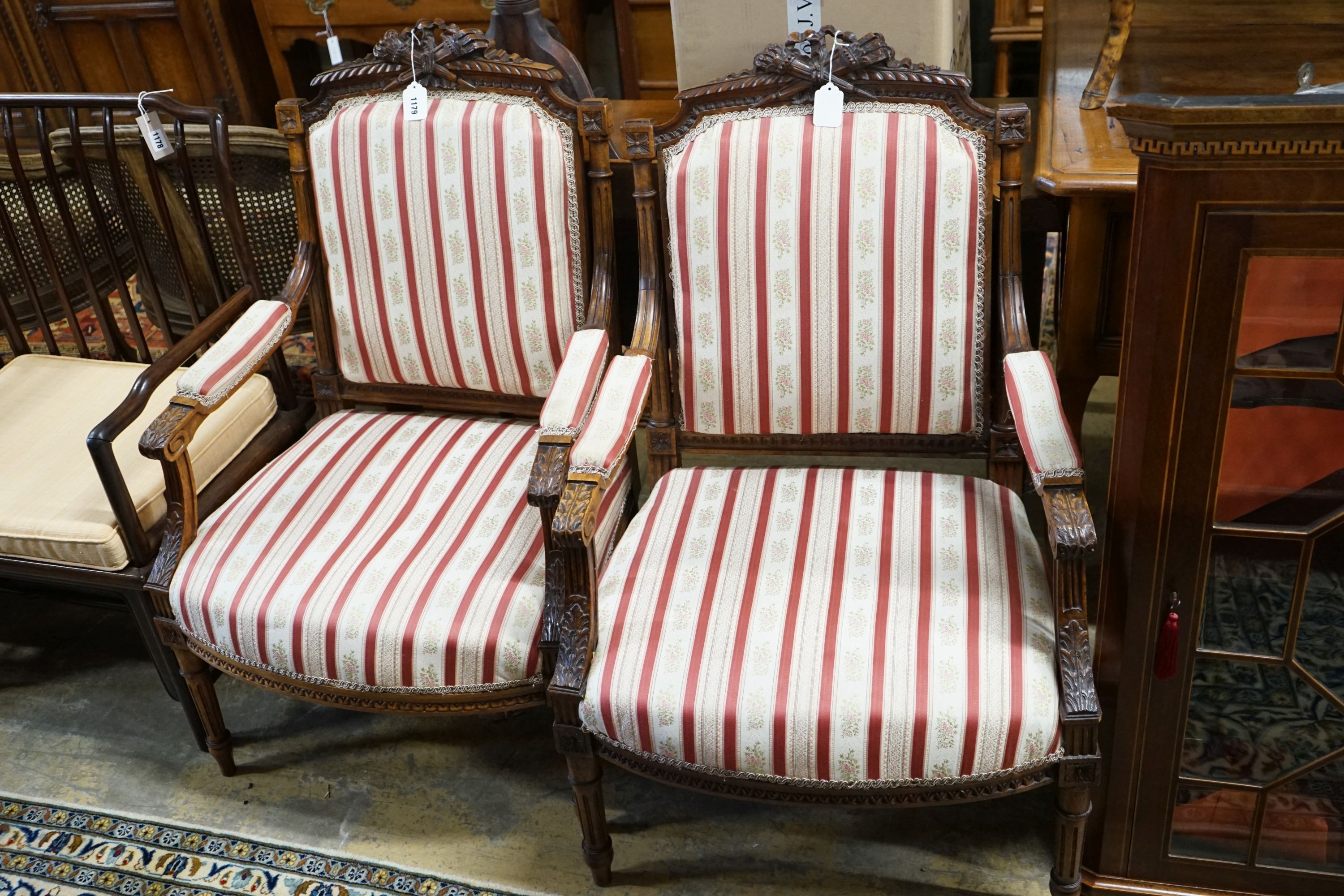 A pair of 19th century French carved walnut elbow chairs, width 61cm, depth 58cm, height 96cm